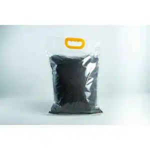 A Manure Bag with a yellow handle, made of clear plastic and filled with dark soil, displayed against a white background.
