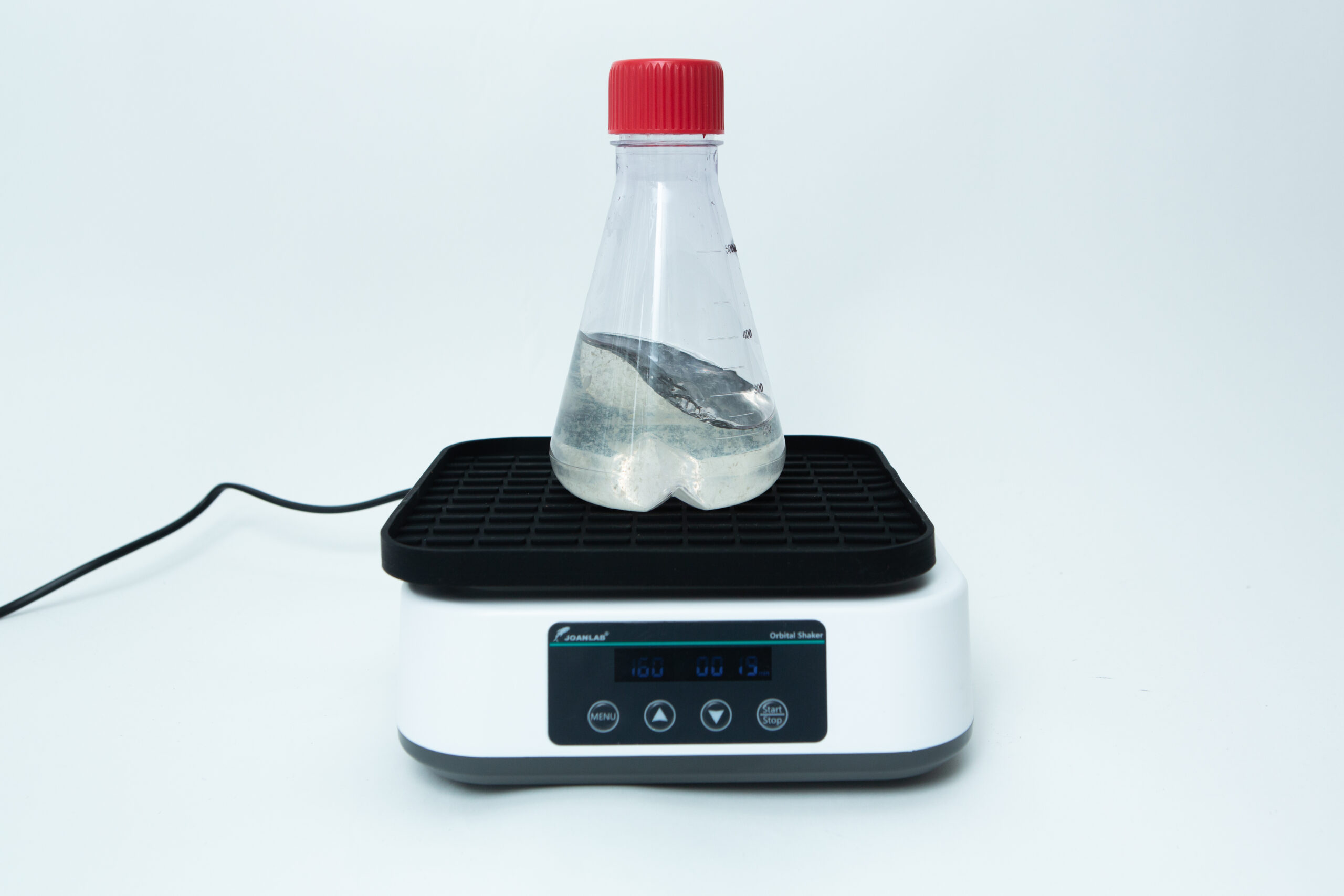 Laboratory Orbital Shaker | 200RPM | 220V | AU Plug 3 A clear bottle with liquid sits on an electronic lab shaker against a white background.