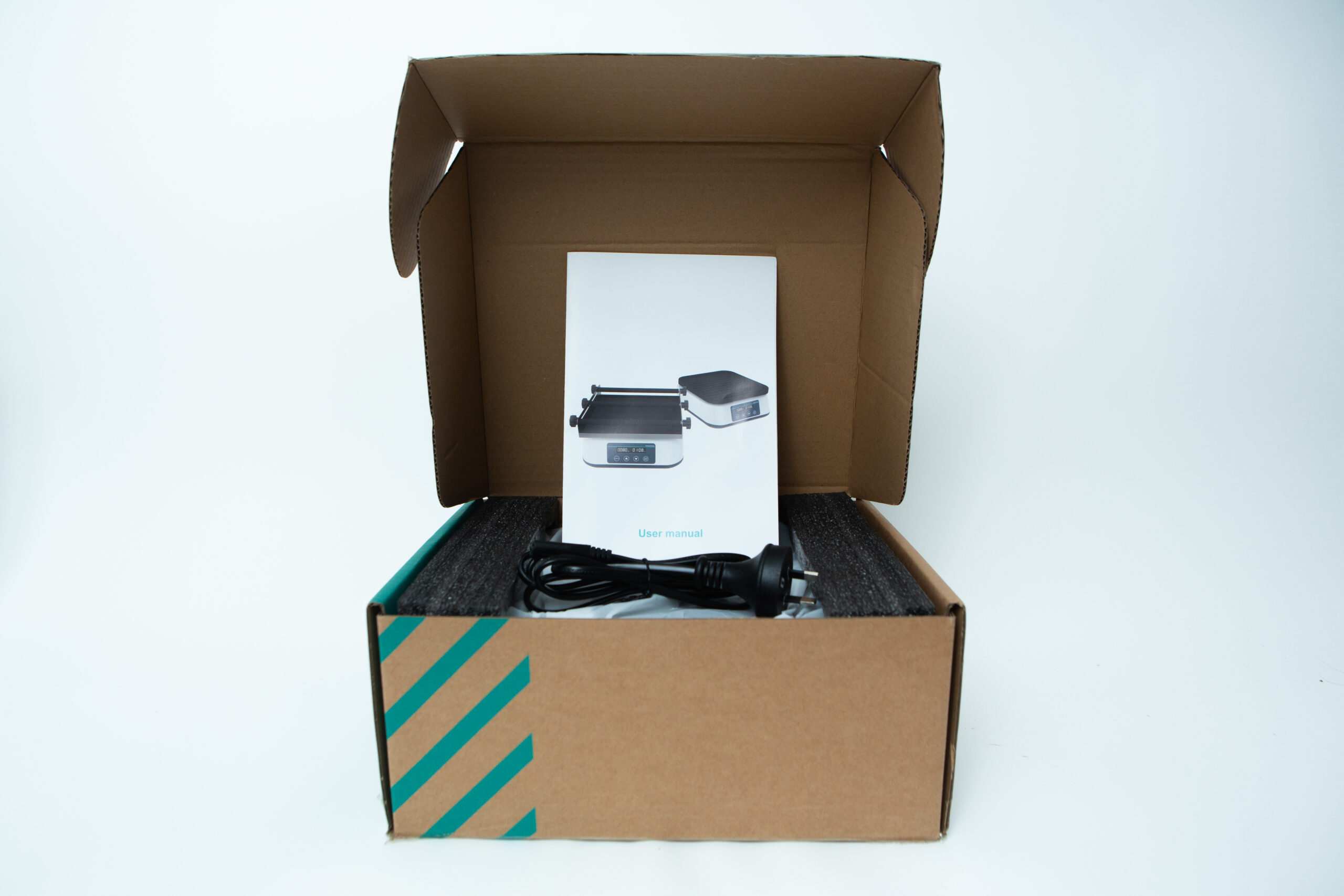 Laboratory Orbital Shaker | 200RPM | 220V | AU Plug 8 Open cardboard box containing an electronic device, user manual, and a power lead on foam padding.