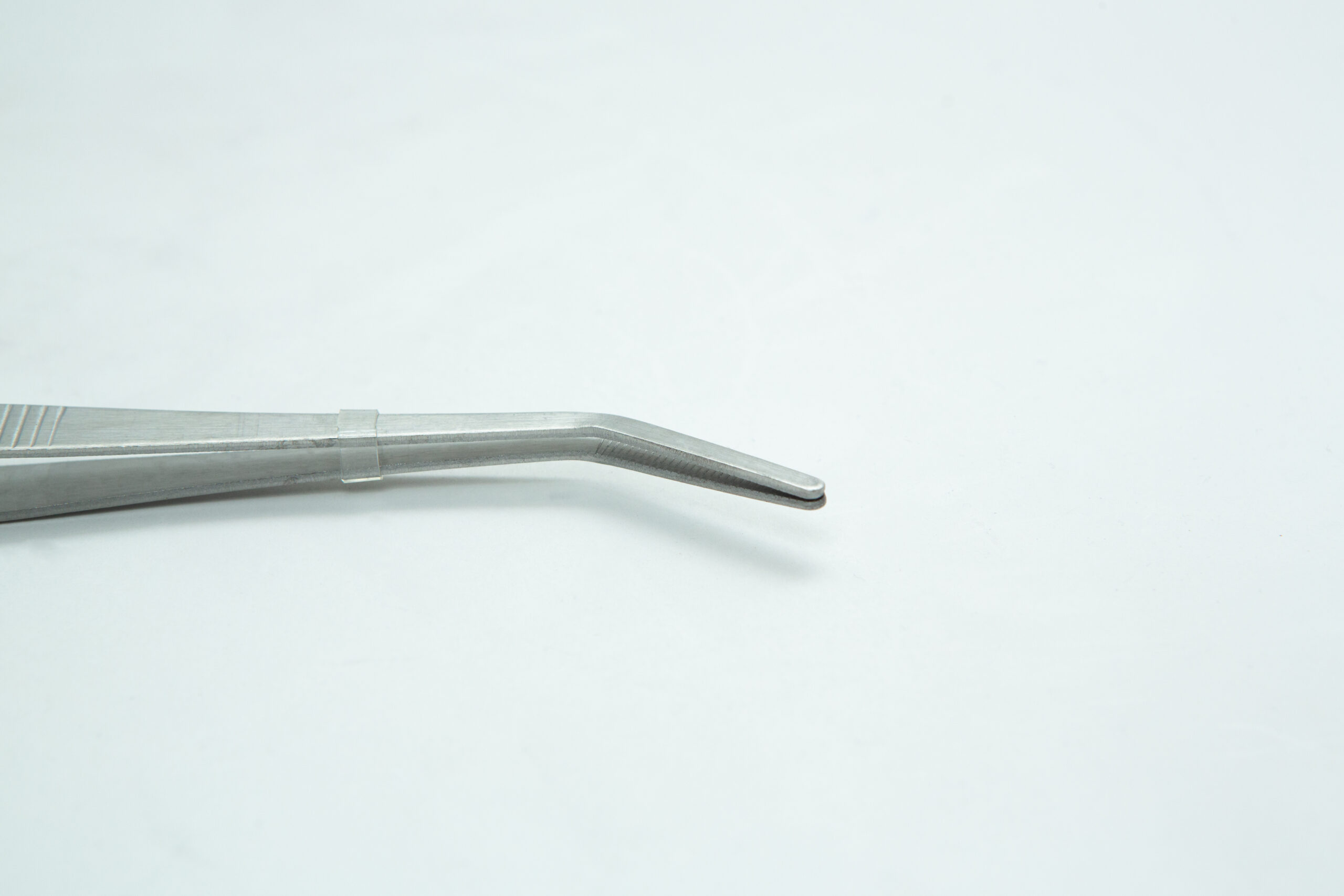 Stainless Steel Plant tissue culture Lab Forceps | Curved & Straight Tips | 15cm 3 A close-up of a metal tweezer with a curved tip against a plain white background.