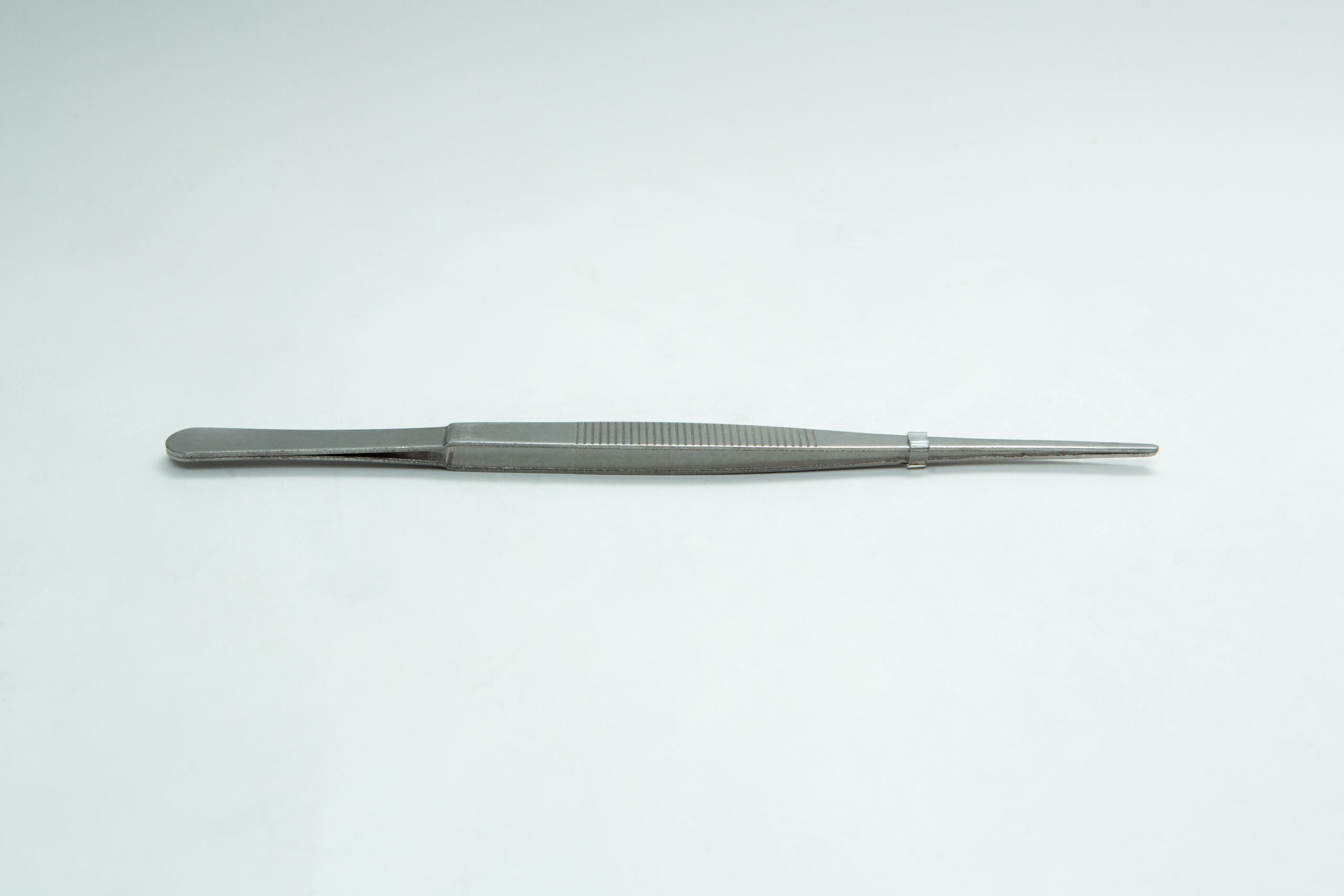 Stainless Steel Plant tissue culture Lab Forceps | Curved & Straight Tips | 15cm 6 A single metal pair of tweezers lies flat on a plain white surface.