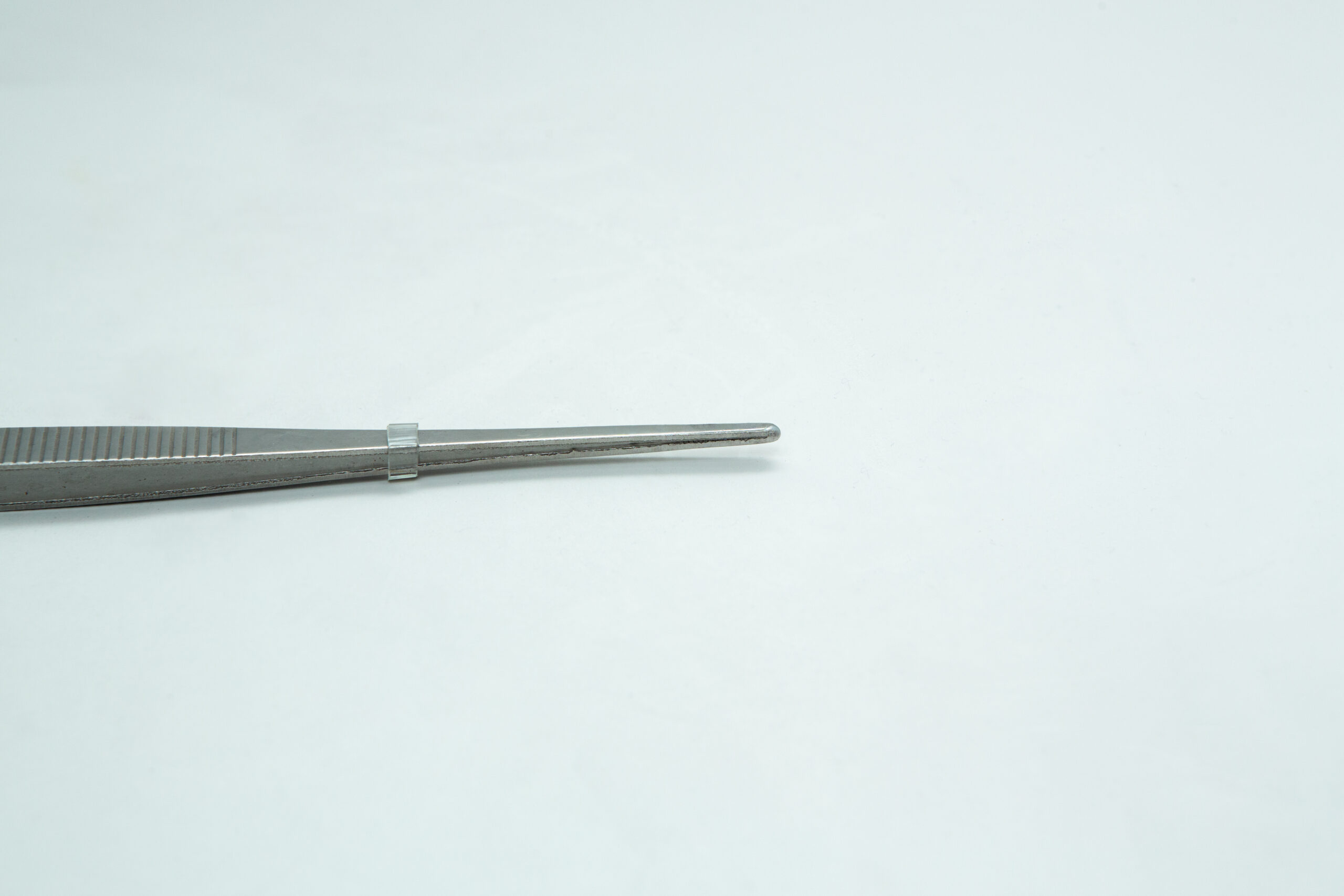 Stainless Steel Plant tissue culture Lab Forceps | Curved & Straight Tips | 15cm 7 A pair of metal tweezers is positioned on a plain white background, pointing to the right.