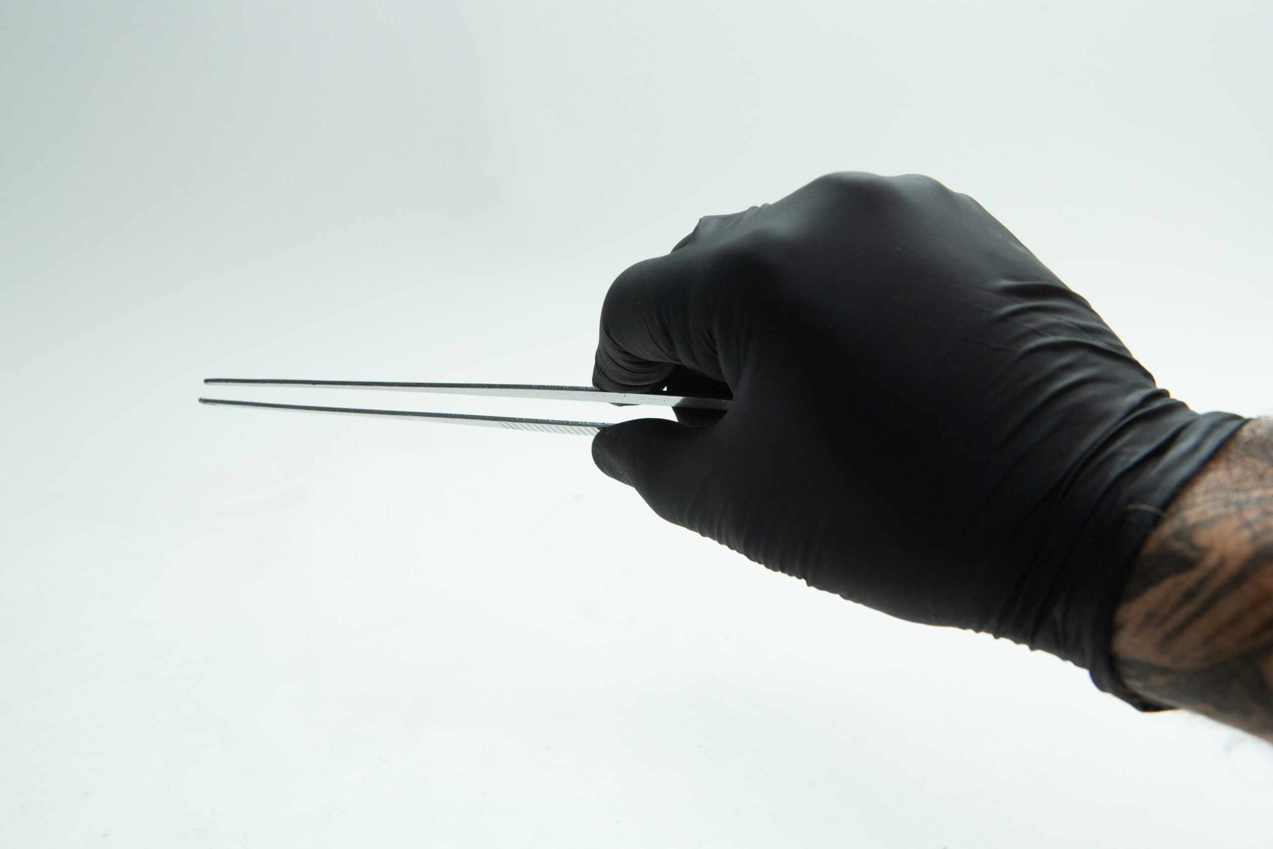 Stainless Steel Plant tissue culture Lab Forceps | Curved & Straight Tips | 15cm 8 A hand in a black glove holding metal tweezers against a white background.