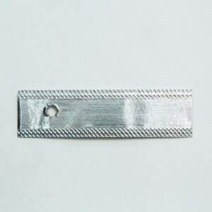 Home 18 A rectangular metallic strip with a small round hole near one end, placed on a plain white background.