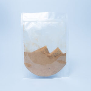 Home 21 Used brown coffee filter with grounds inside a clear resealable plastic bag, isolated on a light background.