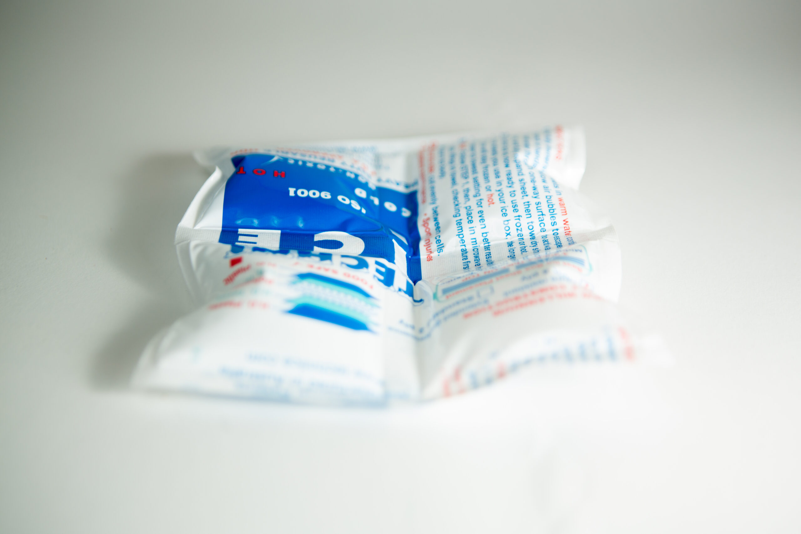 Ice Pack 3 A white and blue rectangular ice pack lies on a plain white surface.
