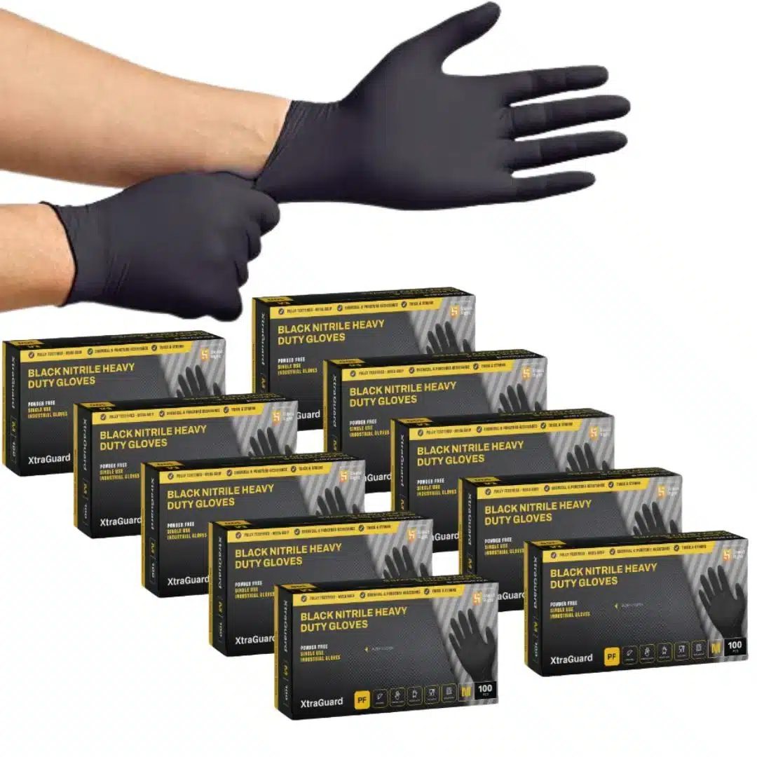 Shield Right, Black Nitrile Gloves - Heavy Duty, 6 Mil, Disposable, Food Safe, Medical Grade 88 Hands putting on a black glove; several boxes of black nitrile heavy-duty gloves are stacked nearby.