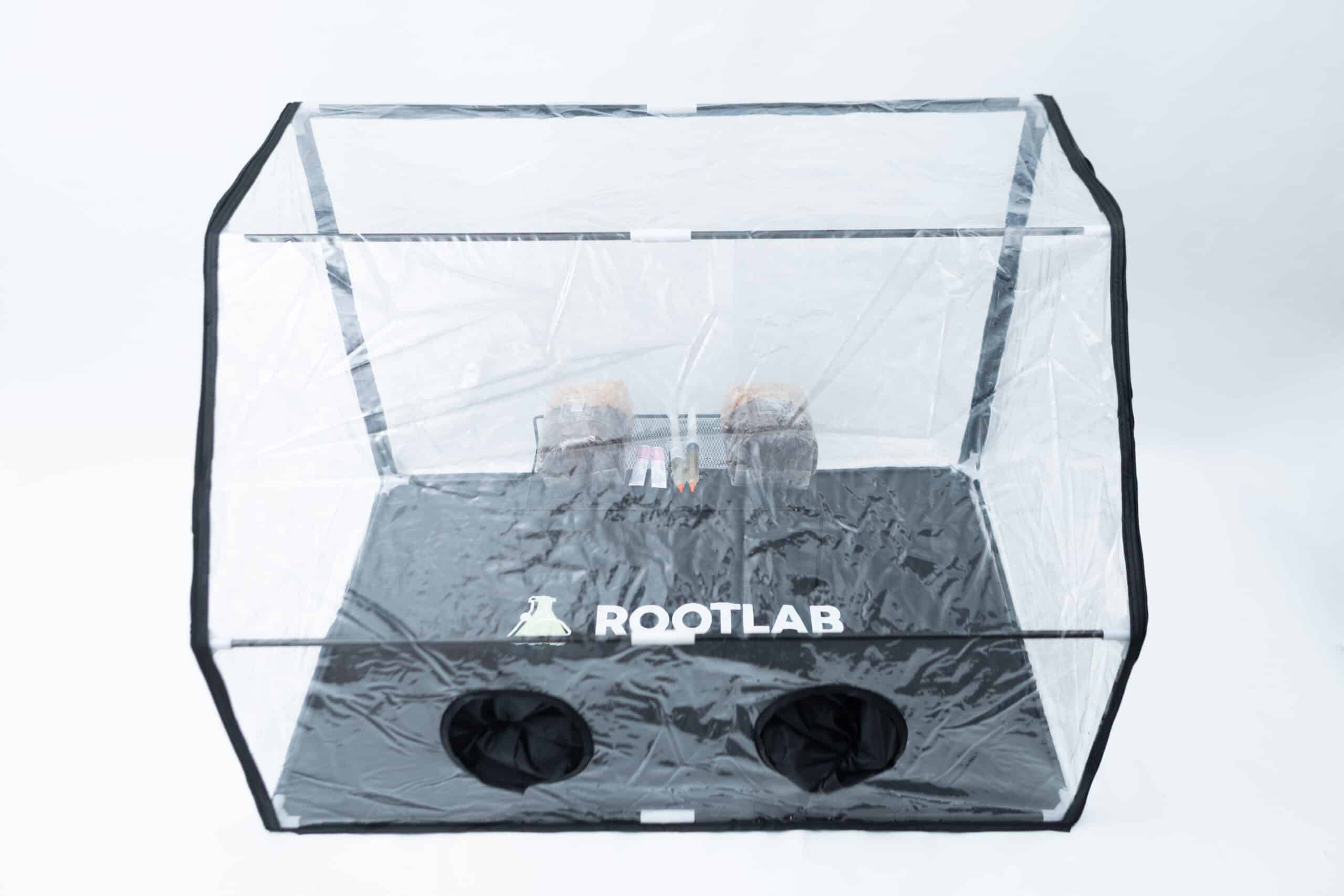Rootlab Still Air Box with viewing Window Angled 2 Rootlab Still Air Box with Viewing Window Angled, featuring the ROOTLAB logo on the base and including small plants and tools inside, all set against a white background.