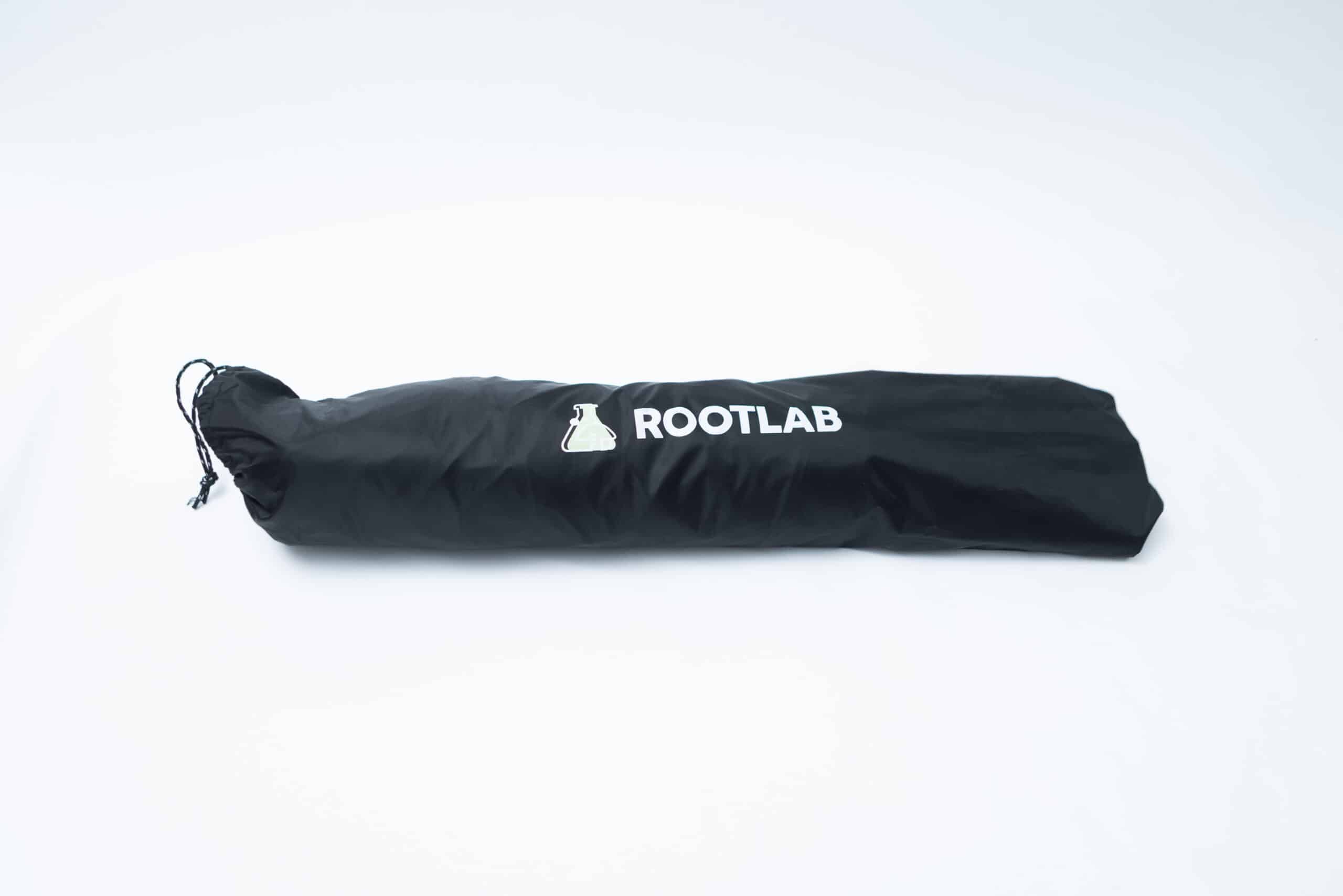 Rootlab Still Air Box with viewing Window Angled 7 A Rootlab Still Air Box with Viewing Window Angled, in black, featuring a drawstring and a convenient viewing window, is lying on a white surface.